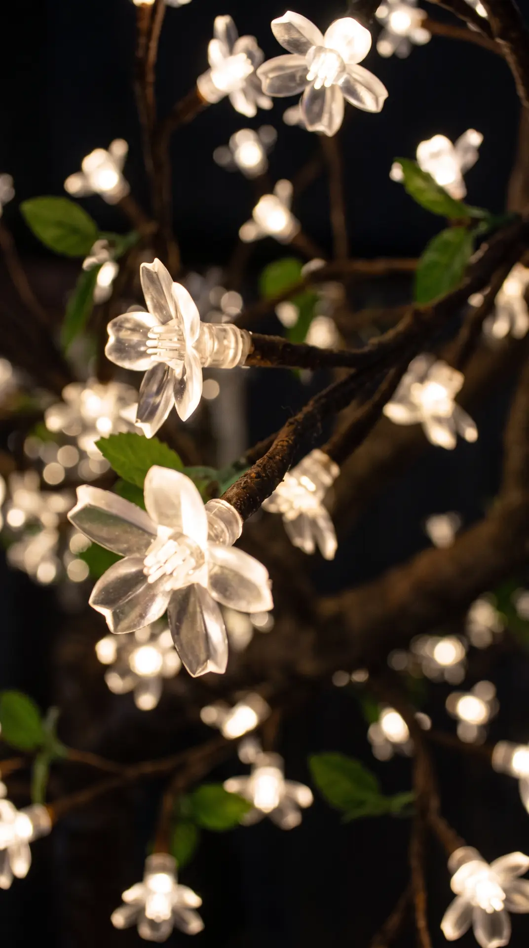 Close-up of warm white LED blossoms on a light tree